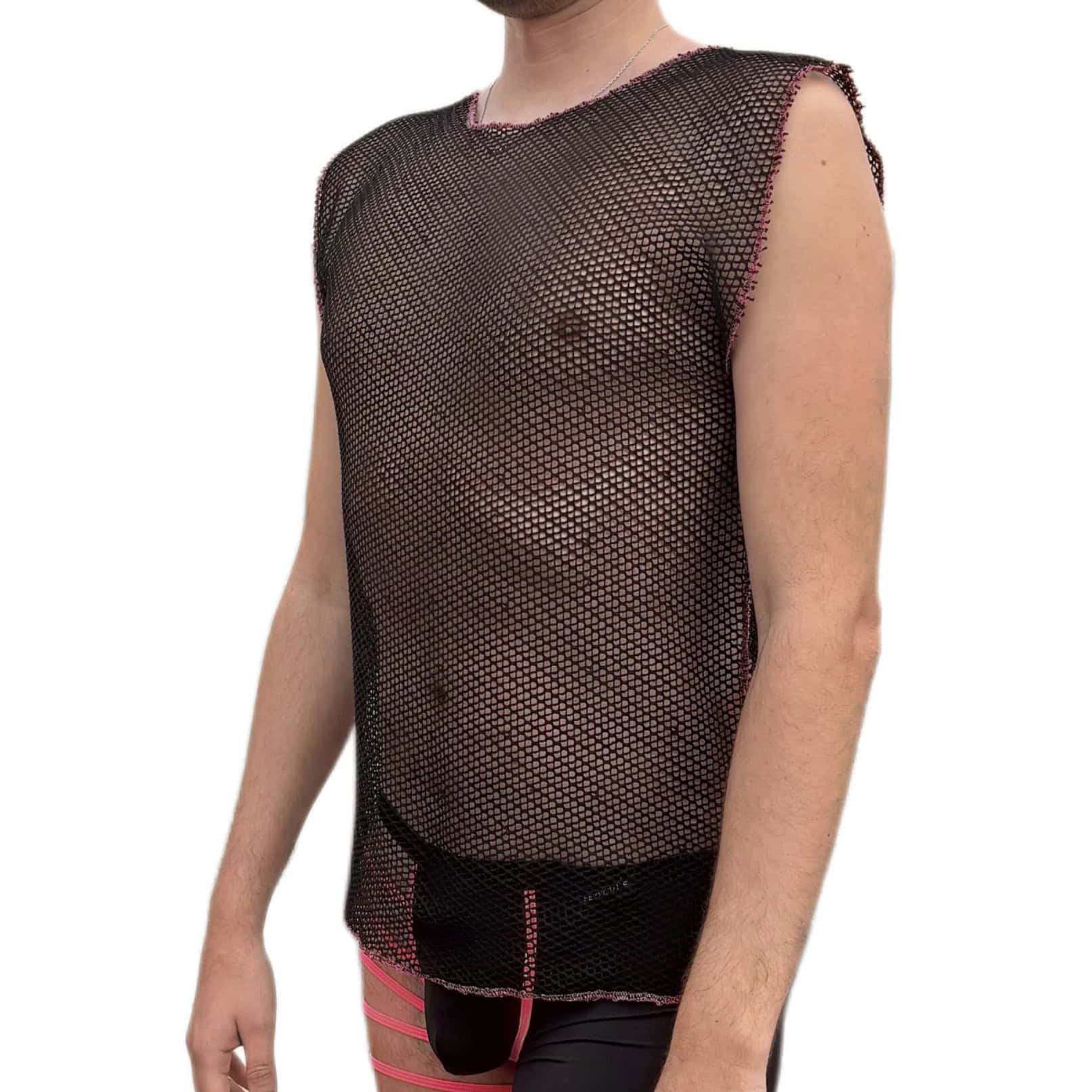 Boy wearing a black mesh shirt and pink shorts.