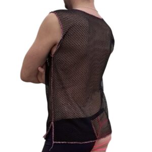 Woman wearing a black mesh top and pink shorts, back view.