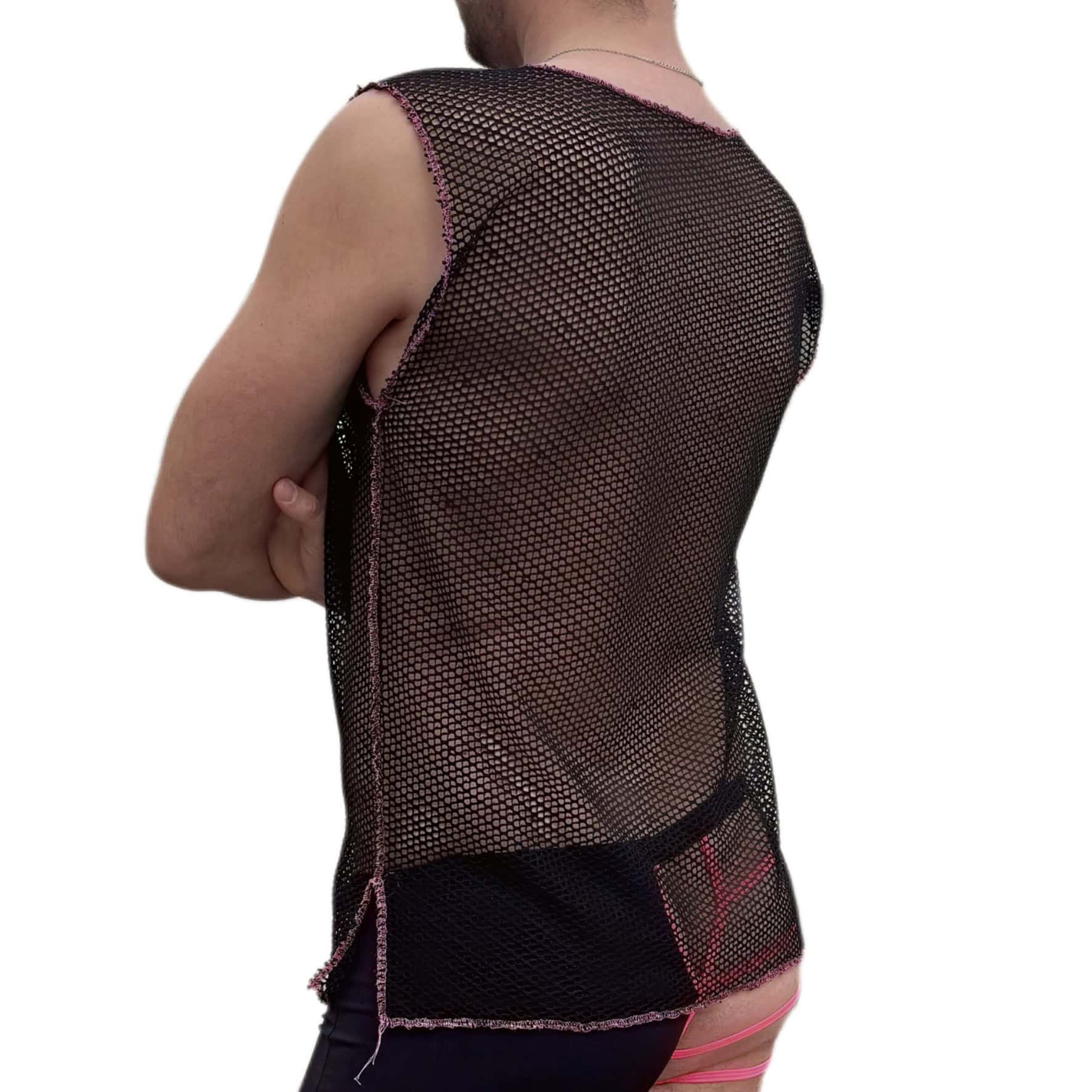 Woman wearing a black mesh top and pink shorts, back view.