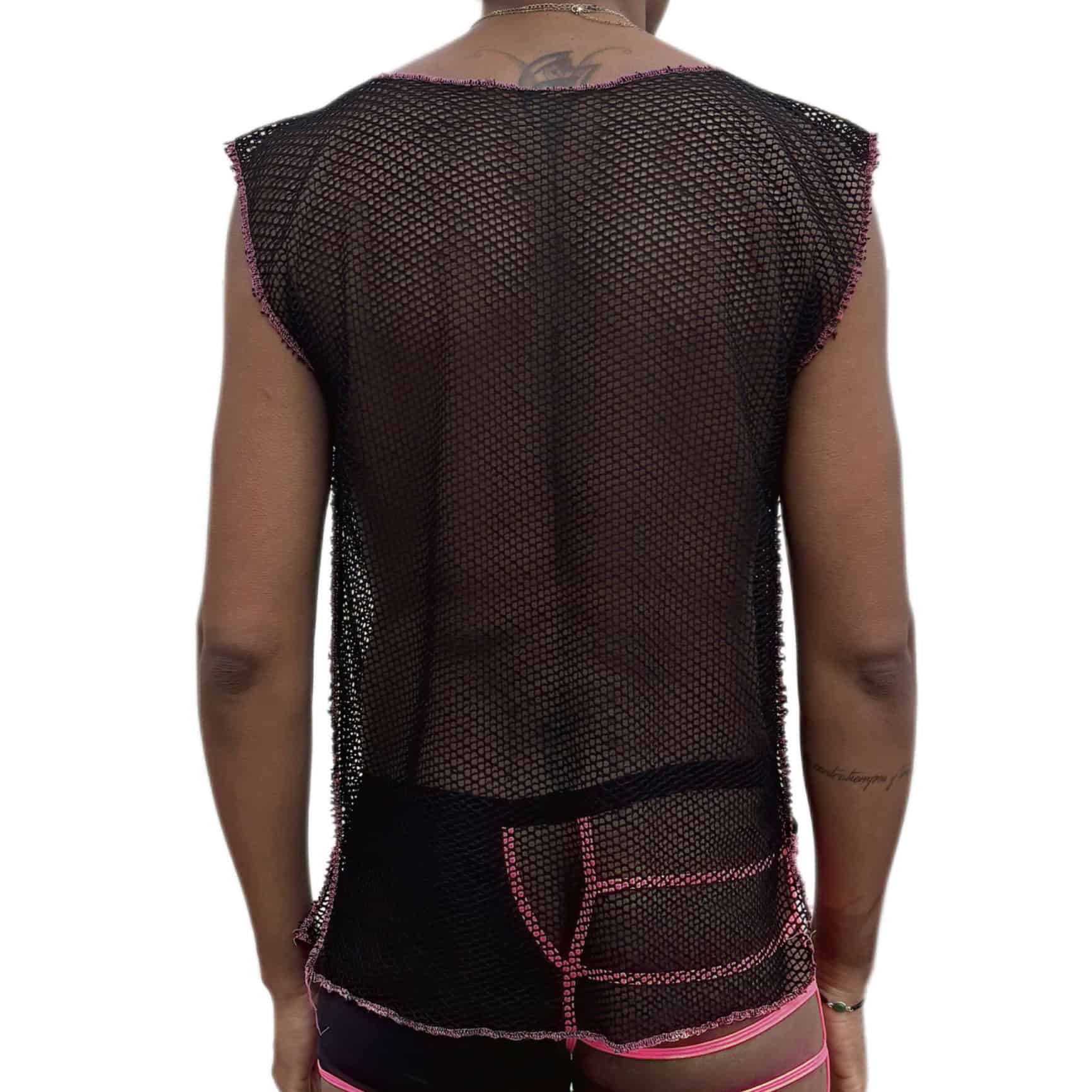 Woman wearing a black mesh top and pink shorts, seen from behind.